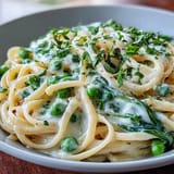 Creamy lemon sauce coats tender linguine and bright green peas in this fresh spring pasta dish.