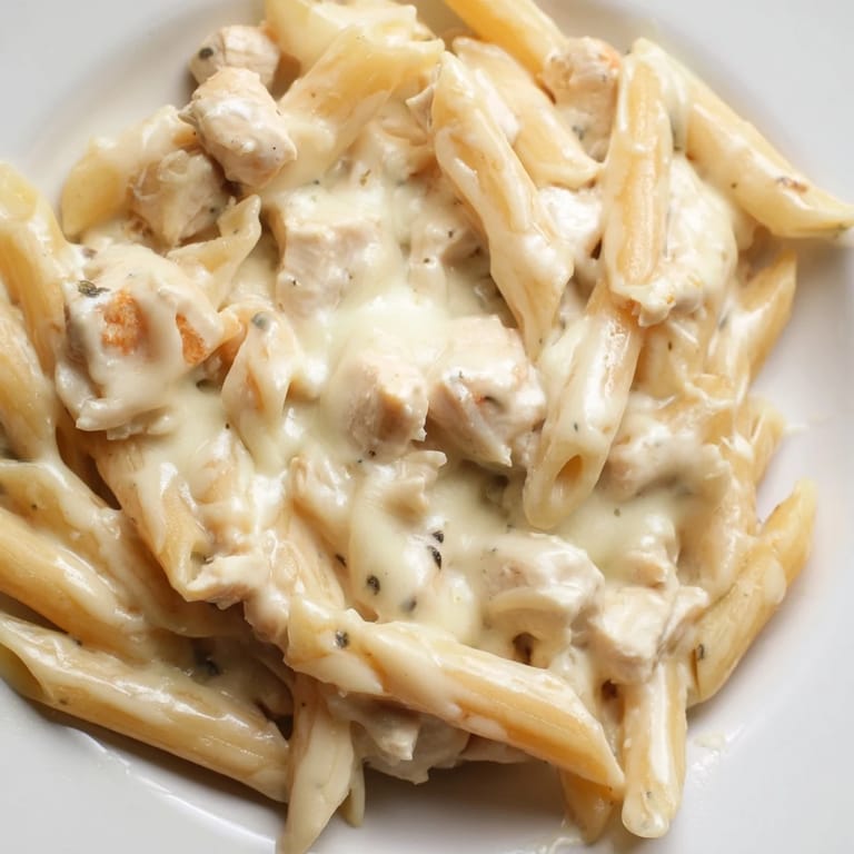 Gooey mozzarella topping on a comforting Chicken Alfredo Casserole, fresh from the oven and ready to serve.