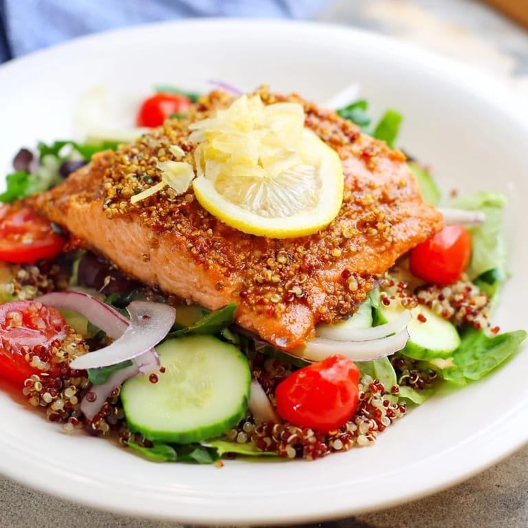 Plated lemon herb salmon salad with fluffy quinoa, crisp mixed greens, and a zesty homemade citrus vinaigrette drizzled over.