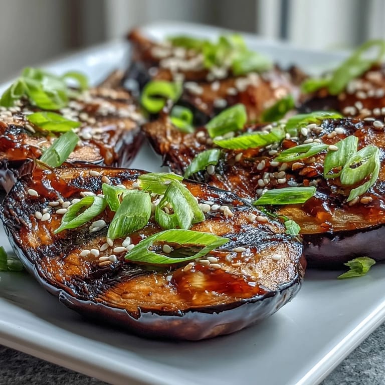 Caramelized Miso Glazed Eggplant fresh from the broiler, featuring silky flesh, glossy glaze, and toasted sesame garnish.
