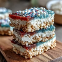 Festive red, white, and blue Rice Krispies treats with vibrant layers, perfect for 4th of July celebrations.